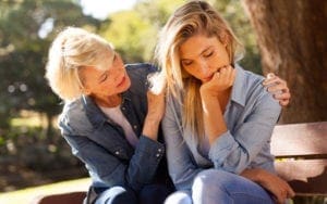 Old women consoling another women